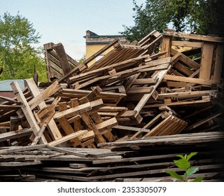 Used wooden pallets piled up. A large number of old pallets for further disposal.