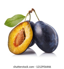 Useful fruits: three ripe prunes isolated on white background