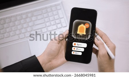User checking smartphone with app notifications and alert messages. Concept of mobile communication, real-time updates, and app interaction.