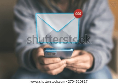 User Checking a Smartphone Displaying a Massive Email Overload Notification with 999 Unread Messages Badge
