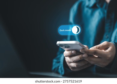 User enabling dark mode on smartphone interface for night viewing and visual comfort. Concept of mobile UI customization, eye care, battery saving display, and digital wellness through dark settings.