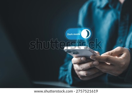 User enabling dark mode on smartphone interface for night viewing and visual comfort. Concept of mobile UI customization, eye care, battery saving display, and digital wellness through dark settings.