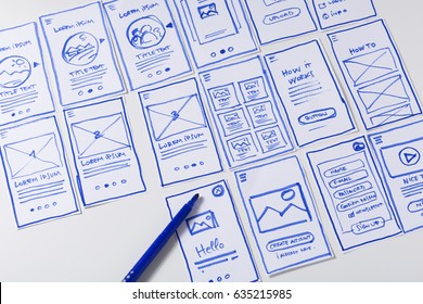 User experience design, desk with paper sketches for mobile interface - Shutterstock ID 635215985