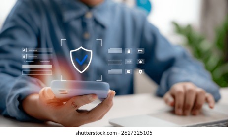 User holding smartphone with virtual shield icon, login interface and secure data system concept