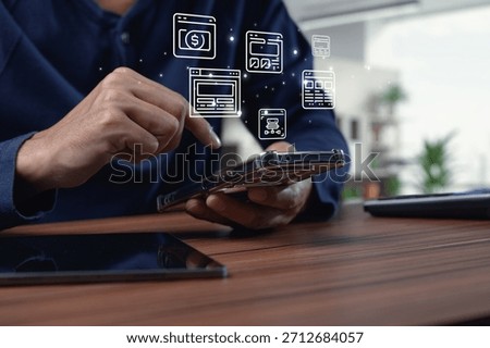 A user interacts with a smartphone displaying various browser interface icons, showcasing the integration of technology in a modern workspace.