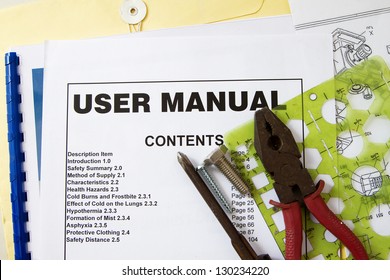 User manual guide brochure against tools and documents.