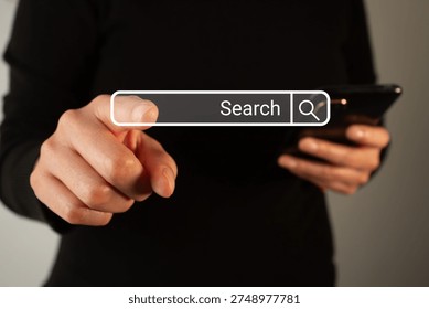 The user points to a web search bar. Ideal for images related to technology, e-commerce, or digital marketing.