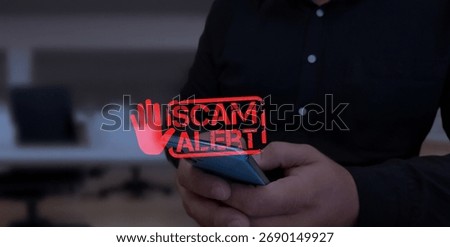 User Receiving a "Scam Alert" Warning on a Mobile Phone.