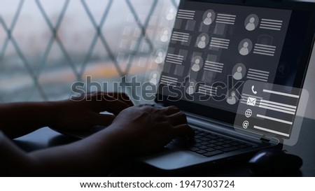 User typing on a laptop with virtual screen of directory contact. Concept for contact us.