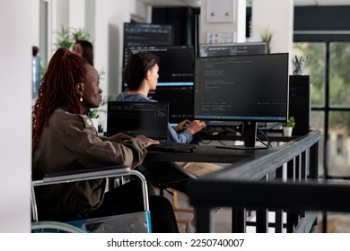 user typing script code on computer, working with cloud computing terminal window. Disabled web developer writing artificial intelligence algorithm in it big data company office.