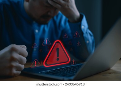 User is using computer with triangle caution warning sign for notification error and maintenance concept. Hacker attacks and hacking data, cyber crime, cybersecurity, Ransomware, Phishing, Spyware. - Powered by Shutterstock