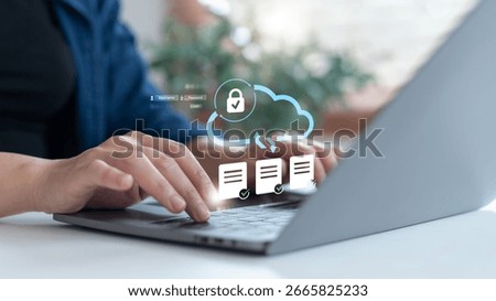 User working on a laptop with a secure cloud storage system, uploading and backing up digital documents, concept of data protection, online file management, and privacy.