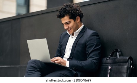 Uses A Laptop , Confident Satisfied Portrait Of An Italian Male Manager In A Formal Suit