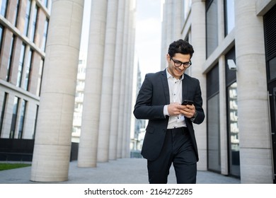 Uses a phone from a businessman a man in a business suit goes to work in the office - Powered by Shutterstock