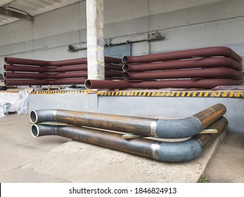 U-shaped Brown Metal Pipe Assembly With Expansion Joints.