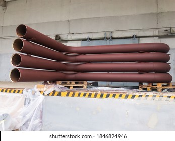 U-shaped Brown Metal Pipe Assembly With Expansion Joints.