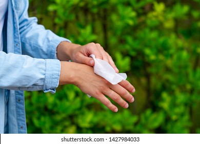 Using Antibacterial Wet Wipes For Cleaning And Disinfection Hands In Park 