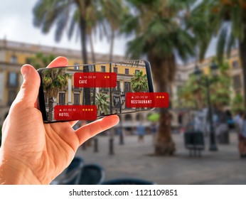 Using Augmented reality while traveling to check hotels, bars and restaurants. Blurred background in Barcelona, Spain.