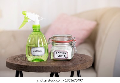 Using Baking Soda Sodium Bicarbonate And White Vinegar For Home Cleaning. White Vinegar In Spray Bottle And Baking Soda In Glass Jar.