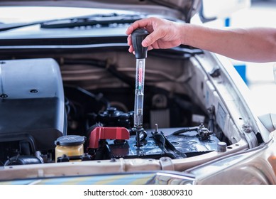 Using the battery hydrometer measuring gravity of battery distilled water, maintenance cars battery concept.