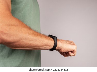 Using Black Smart Fitness Watch, Bracelet On Men Hand. High Quality Photo