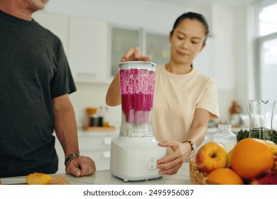 Using Blender in Bright Kitchen for Making Smoothie