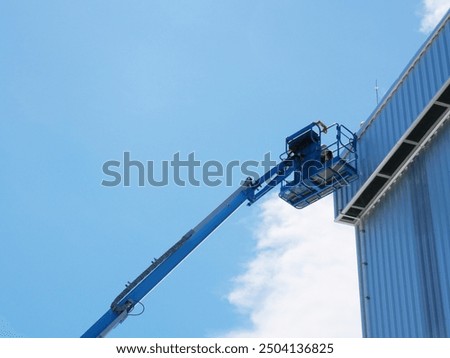 Using a boom truck to work on the roof of a tall building