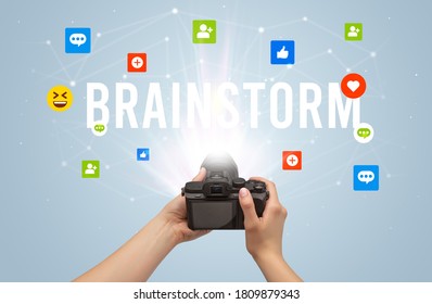 Using camera to capture social media content with BRAINSTORM inscription, social media content concept