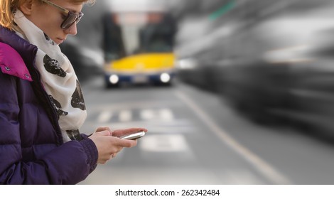 Using cellphone outdoors while crossing the street. Danger! - Powered by Shutterstock