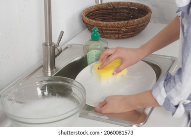 Using Cleaning Soap, Person Cleaning Dishes.