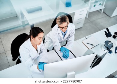 Using clinical trials and investigative methods to reach their findings. two scientists working together on a computer in a lab. - Shutterstock ID 2297780907