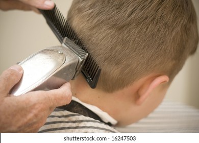 Using Clippers On Young Boy's Hair Cut