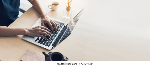 using computer.hand typing keyboard laptop online chatting search form internet while working sitting at coffee shop.concept for.technology device contact communication business people - Shutterstock ID 1774949384