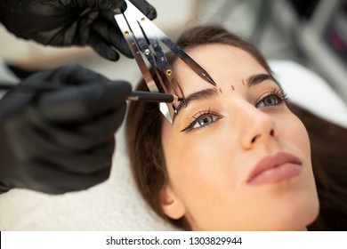 Using Cosmetics Tools For Taking The Correct Measure Of Future Eyebrows Done With Microblading Technique