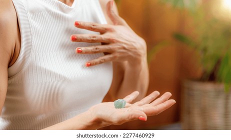 Using a crystal for improvement of energy circulation in Anahata, heart chakra. Chakras, energy centers in the body, govern certain physical, emotional and spiritual functions.  