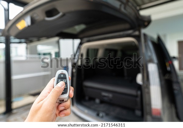 Using digital remote key to opening the rear truck
door of van vehicle. Transportation technology and equipment object
photo.