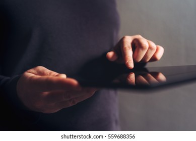 Using digital tablet computer for internet browsing, woman holding electronics device