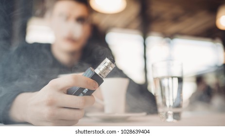 Using Electronic Cigarette To Smoke In Public Places.Smoke Restriction,smoking Ban.Using Vaping Device With Flavoured Liquid.E-juice Vaping New Technology.Give Up Tobacco.Smoking Habit,nicotine Addict