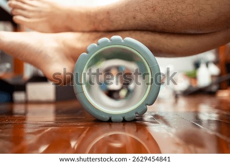 Using foam roller to stretch calf muscle and relieve heel pain. Foam roller exercises are helpful for a runner's recovery.