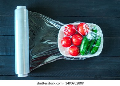 Using food film for vegetables storage in fridge. Top view 
