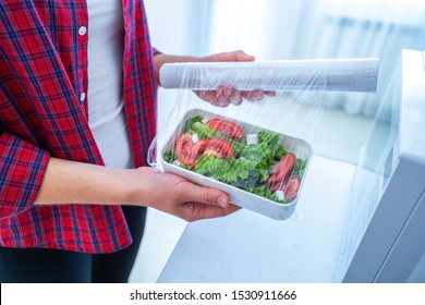 Using food polyethylene plastic film for food storage in fridge at home 