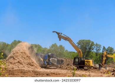 Using forestry mulcher, we loaded roots from trees to an industrial shredder machine that chopped