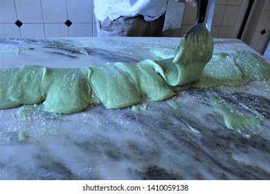 Using Hand Paddle To Work The Fudge Into Loaves On A Marble Slab, Fudge Maker Makes Local Candy Favorite Key Lime Pie In Key West In The Florida Keys. This Sweet Confection Is Popular The World Over. 