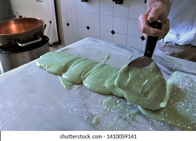 Using Hand Paddle To Work The Fudge Into Loaves On A Marble Slab, Fudge Maker Makes Local Candy Favorite Key Lime Pie In Key West In The Florida Keys. This Sweet Confection Is Popular The World Over. 