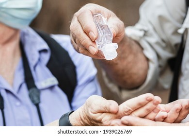 Using hand sanitizer while traveling in the new normal - Powered by Shutterstock