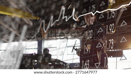 Using handheld tool, gloved metal tech in workwear at shop with stock market overlay, copy space. Hammer, workshop, machinery, industrial, backlit, highcontrast, doubleexposure