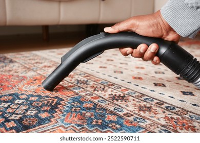 Using a handheld vacuum cleaner to effectively vacuum and clean a colorful area rug thoroughly