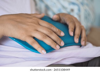 Using a heating pad for relief on a cozy sofa