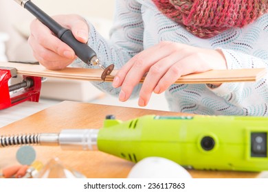 Using a high speed rotary multi tool to cut a wooden batten - Powered by Shutterstock