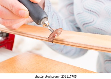 Using a high speed rotary multi tool to cut a wooden batten - Powered by Shutterstock